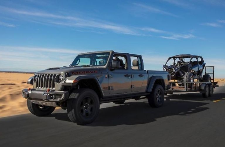 Image showing rear view of a silver 2022 Jeep Gladiator driving on a road